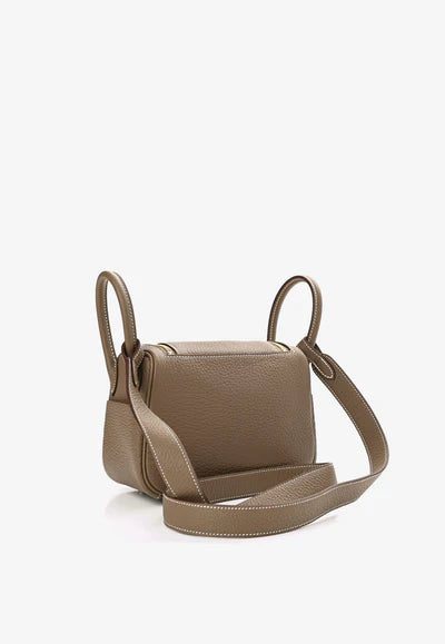 1001915A_400x_9c47edcb-5fcc-4c28-853d-1159cdd23757.jpg Hermès Mini Lindy 20 in Etoupe Taurillon Clemence with Gold Hardware bag