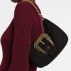 18723531_40460639_1000.jpg Versace logo-buckle shoulder bag