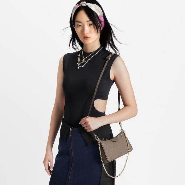 louis-vuitton-easy-pouch-on-strap-monogram-empreinte-wallets-and-small-leather-goods-M81862_PM1_Croppedwornview.jpg Louis Vuitton Easy Pouch On Strap