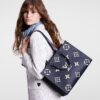 louis-vuitton-onthego-mm-bicolor-monogram-empreinte-leather-handbags-M47084_PM1_Croppedwornview_1.jpg Louis Vuitton OnTheGo MM