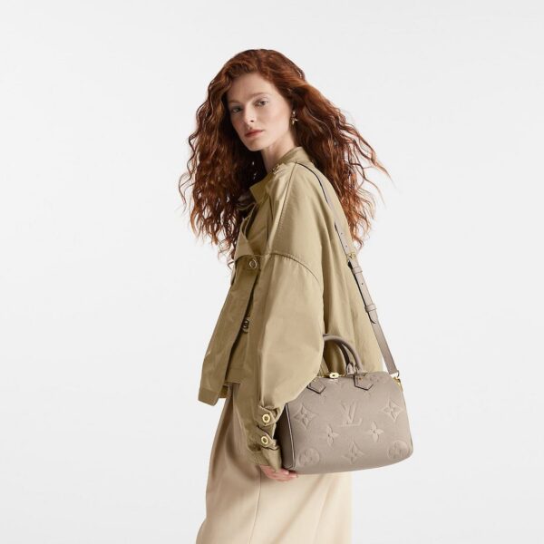 louis-vuitton-speedy-bandouliere-25-monogram-empreinte-handbags-M59273_PM1_Croppedwornview.jpg Louis Vuitton Speedy Bandoulière 25