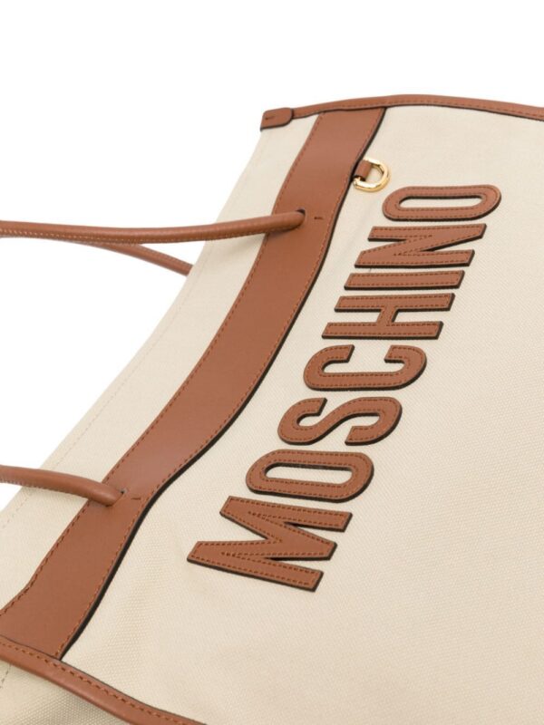 22303327_52175882_1000.jpg Moschino logo-patch canvas shoulder bag