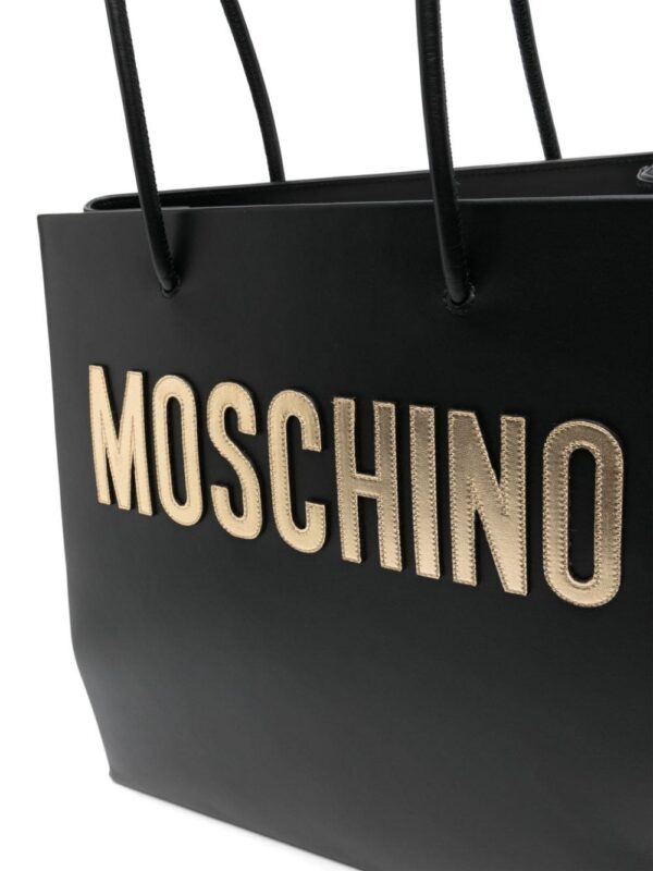22947713_53193563_1000.jpg Moschino logo-patch leather shoulder bag