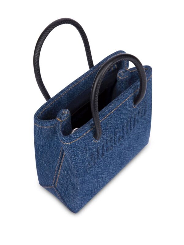23720440_53593432_1000.jpg Moschino logo-embossed denim mini bag