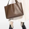 23857941_53834975_1000.jpg Stella McCartney logo-perforated faux-leather tote bag